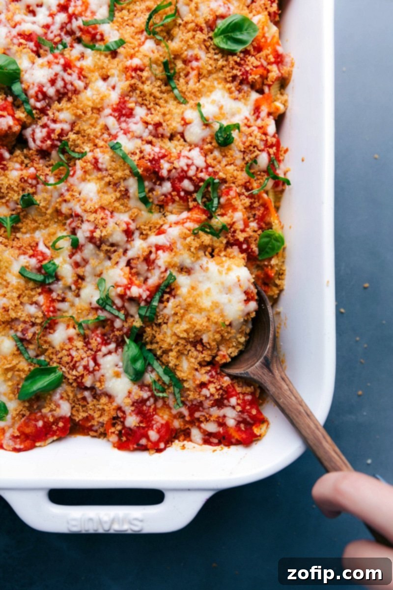 Hearty Meal Ready to Enjoy, with a Scoop Taken A finished, warm, and hearty meal, with a scoop being taken.