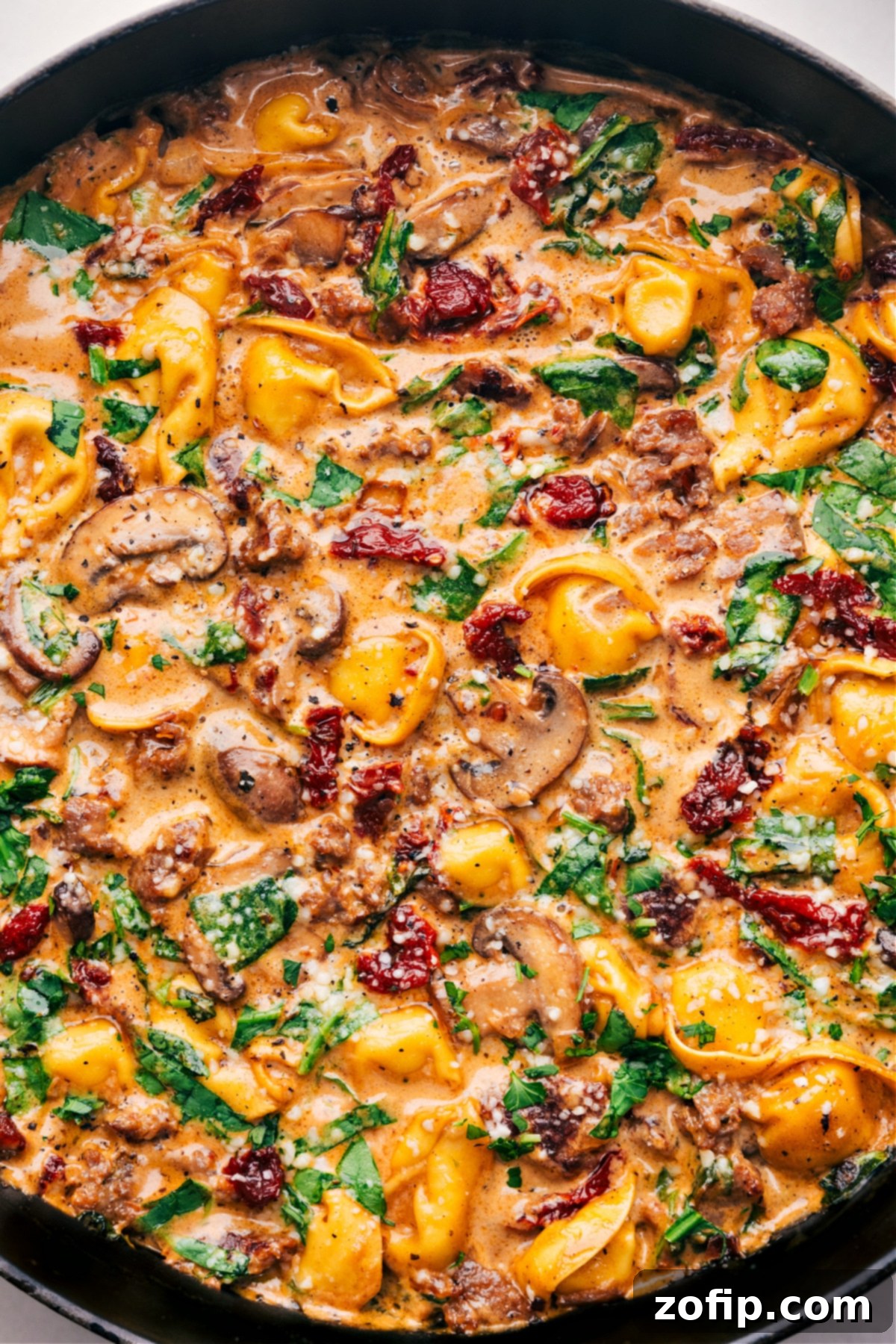 Sausage Tortellini Bake ready to be enjoyed with a sprinkle of herbs.
