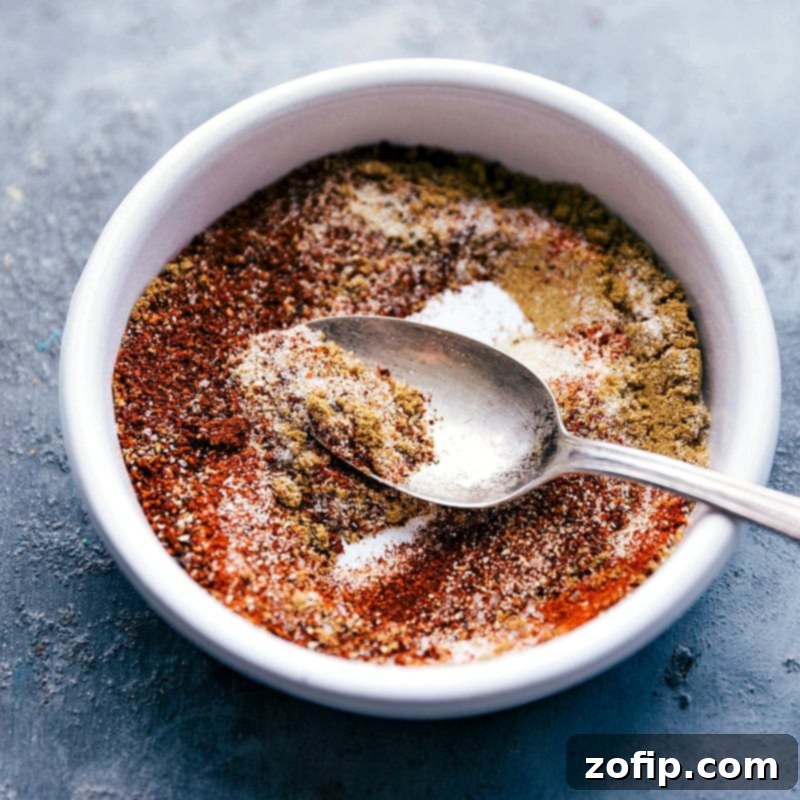 A close-up shot of a vibrant, aromatic seasoning mix, meticulously prepared to infuse the crockpot quinoa chili with rich and complex flavors.