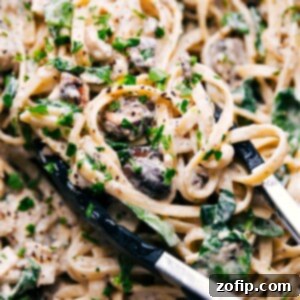 A bowl of the finished creamy chicken pasta with fresh parsley garnish.