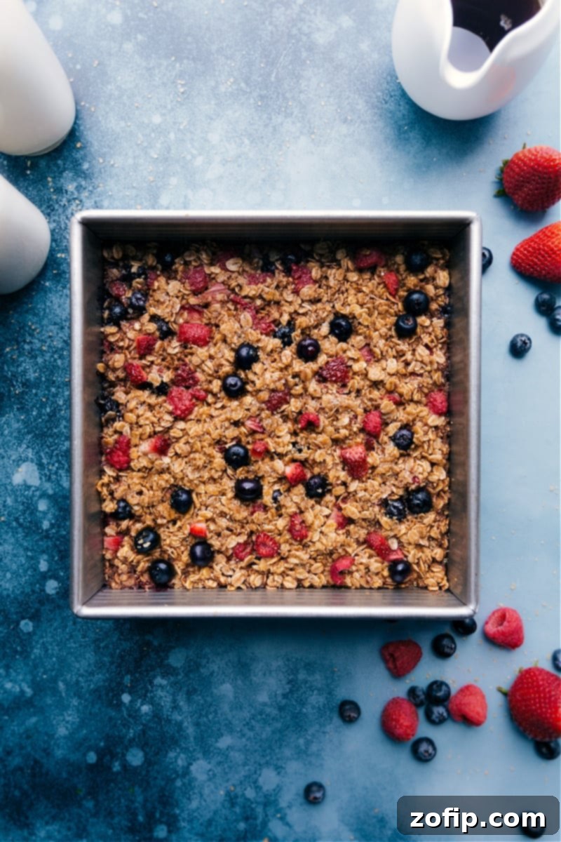Overhead image of the Baked Oatmeal, showing a perfect golden-brown crust and fresh berries.