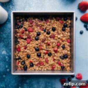 Freshly baked berry oatmeal, cut into squares in a baking dish