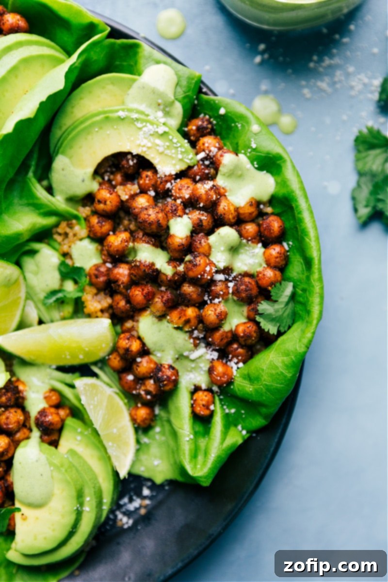 Mexican Chickpeas served in crisp lettuce wraps, garnished with fresh cilantro and a lime wedge, offering a light and healthy meal option.