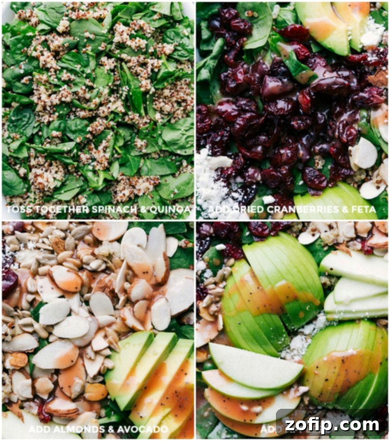 A beautifully arranged Quinoa and Almond Salad with distinct layers of spinach, cooked quinoa, dried cranberries, crumbled feta cheese, sliced almonds, ripe avocado, and crisp apple slices.