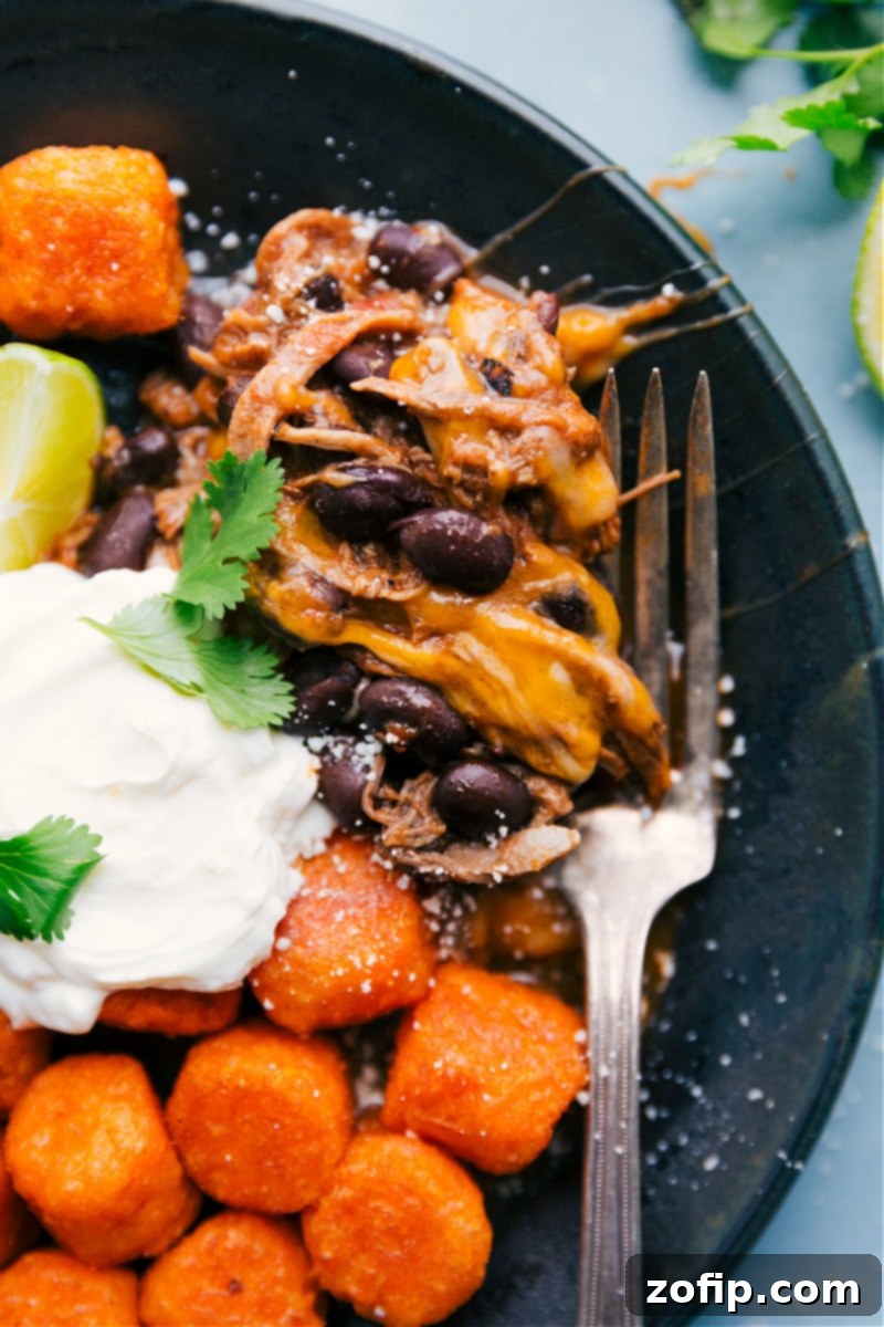 A close-up of a plate of Deconstructed Beef Totchos with all the toppings, ready to eat