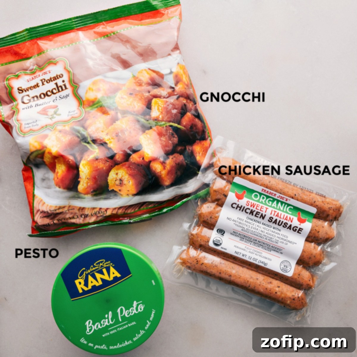 Close-up of roasted sweet potato gnocchi and chicken sausage on a sheet pan, showing the golden-brown crispness