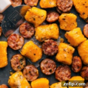 Final plated dish of roasted sweet potato gnocchi and Italian chicken sausage with pesto