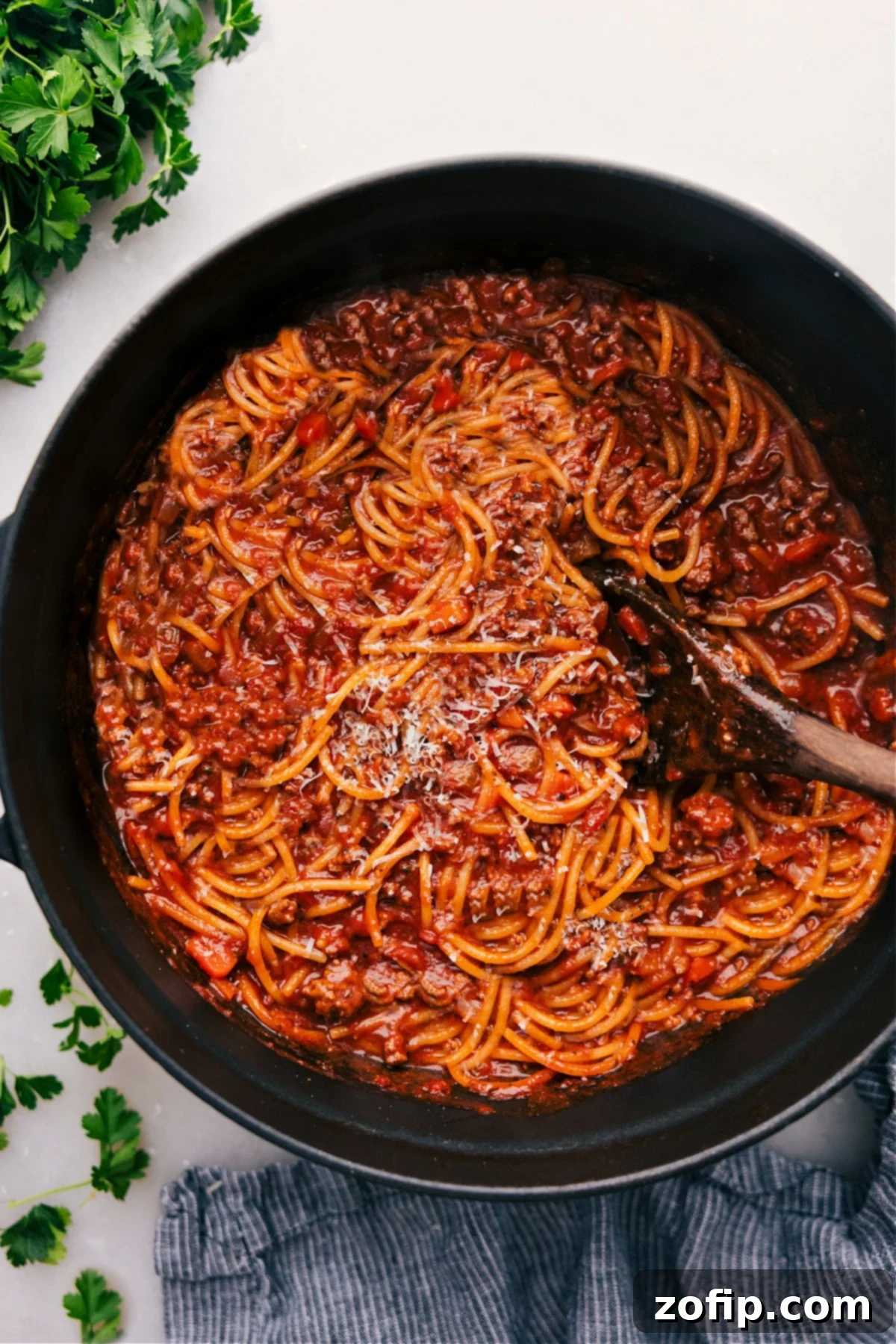 Delicious One Pot Spaghetti One Pot Spaghetti freshly cooked in the pot, garnished with fresh herbs.