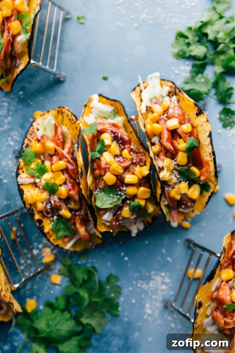 Delicious BBQ Chicken Tacos with creamy coleslaw, vibrant corn, and fresh cilantro, served in warm tortillas.