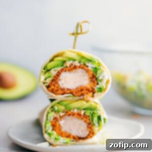 Ultimate Chicken Caesar Wraps 3 Chicken Caesar Wrap cut in half showing the insides of one of the wraps.