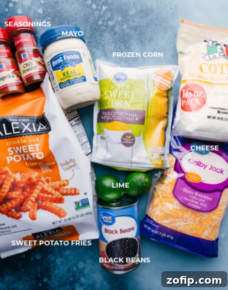 Gather your ingredients for Sweet Potato Nachos: seasoned sweet potato fries, corn, black beans, cheese, and fresh toppings. Simple, wholesome, and delicious! A flat lay image displaying all the fresh and vibrant ingredients needed to make delicious Sweet Potato Nachos.