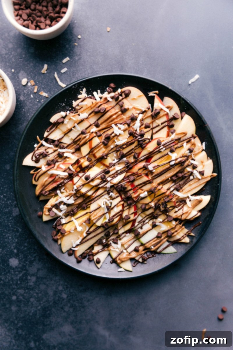 Overhead image of a chocolate-drizzled version of Apple Nachos, showcasing decadent dessert toppings.