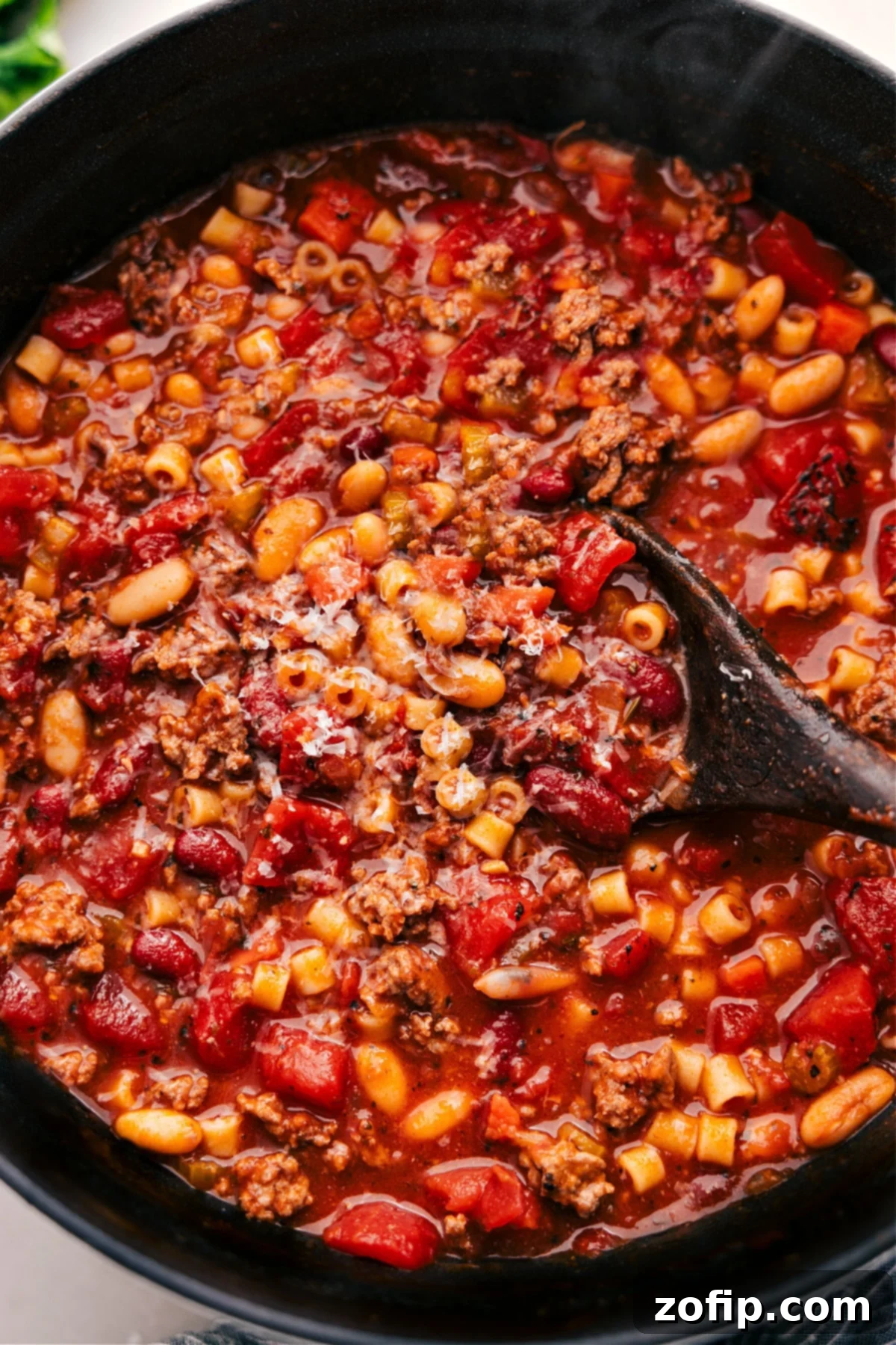 The Best Olive Garden Copycat Pasta E Fagioli Recipe A warm bowl of Olive Garden Copycat Pasta e Fagioli soup, garnished with fresh parsley and Parmesan cheese, ready to be enjoyed.