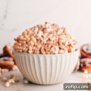 A small, artfully arranged bowl of fresh Cinnamon Roll Popcorn, glistening and ready to be served and enjoyed.