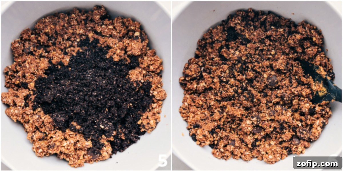 The homemade 'Oreo' crumble being gently folded into the smooth, blended energy bite base, creating a beautiful contrast and the signature cookies and cream look.