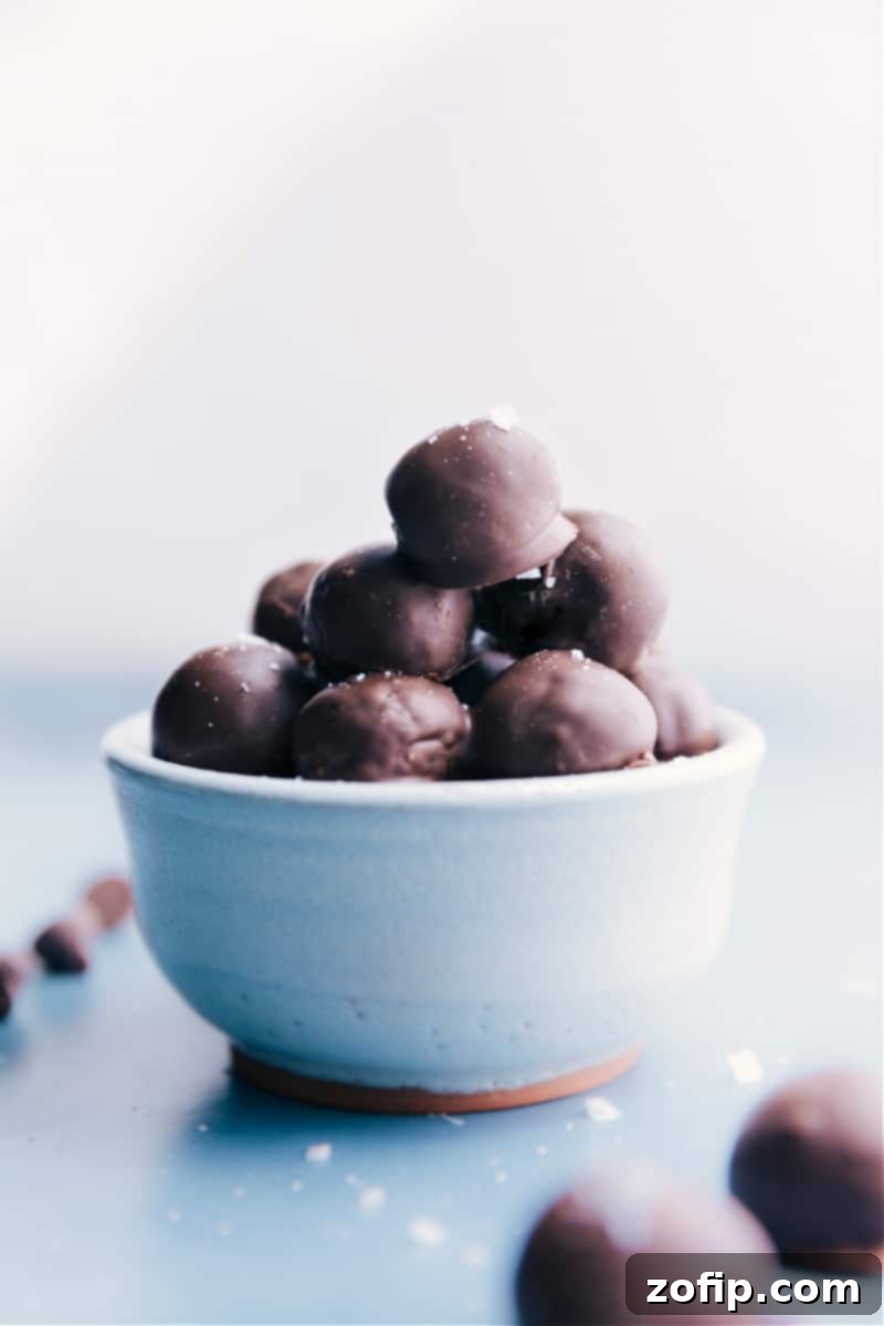 A bowl filled with freshly made Healthy Chocolate-Covered Date Caramels, showcasing their rich dark chocolate coating and appealing texture. Perfect for a refined sugar-free dessert.