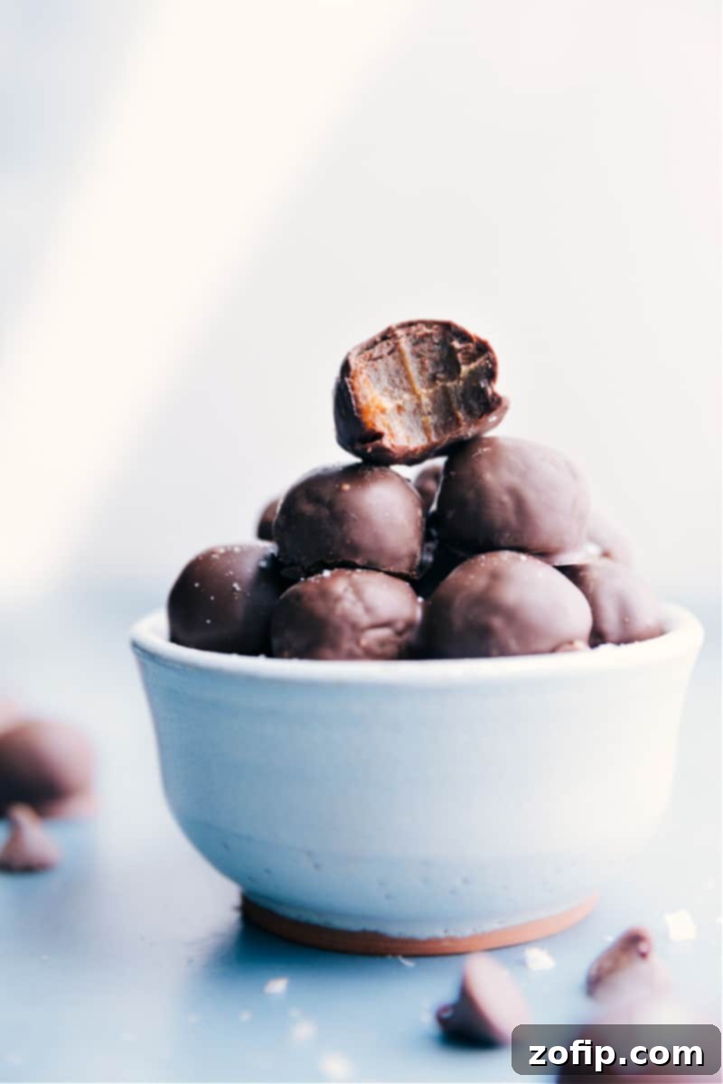 A beautifully arranged bowl overflowing with finished Healthy Chocolate-Covered Date Caramels, ready to be enjoyed as a wholesome, refined sugar-free dessert.