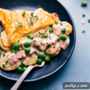 Home-Style Ham and Potato Pot Pie 2 Finished Ham and Potato Pot Pie with a golden, flaky crust and a warm, bubbly filling visible around the edges.