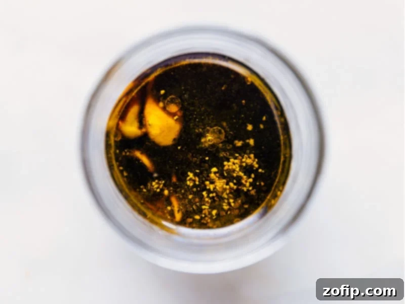 Overhead view of all the ingredients for the balsamic vinaigrette, neatly arranged before mixing, highlighting their fresh quality.