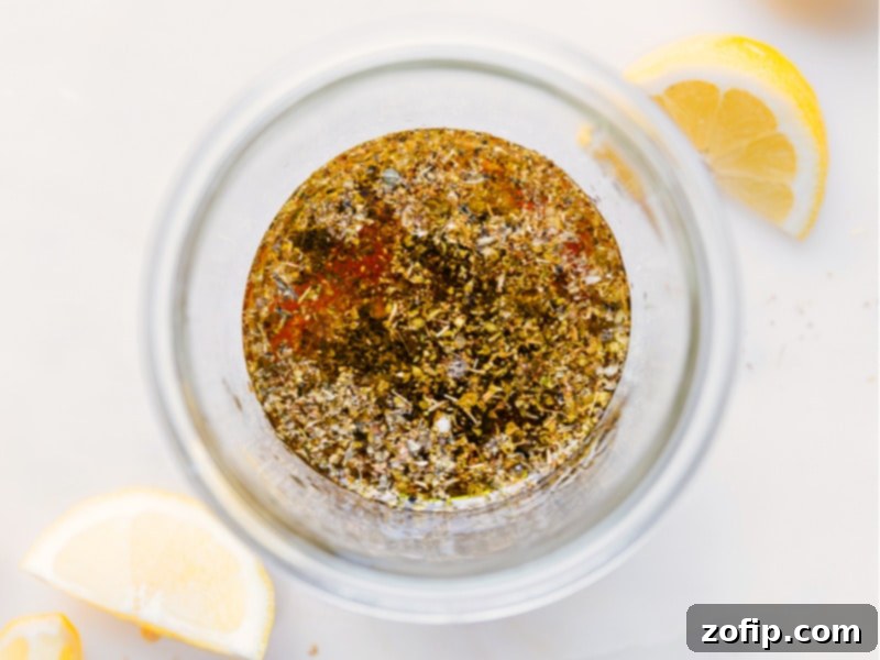 Process images showing all the fresh ingredients being added to a glass jar to make the Greek Salad Dressing.