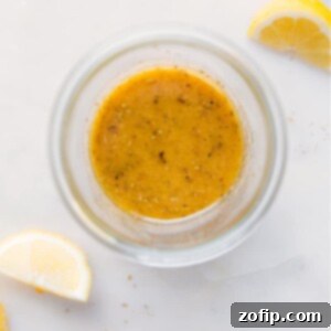 A close-up image of the finished Greek Salad Dressing in a jar, ready to be served.
