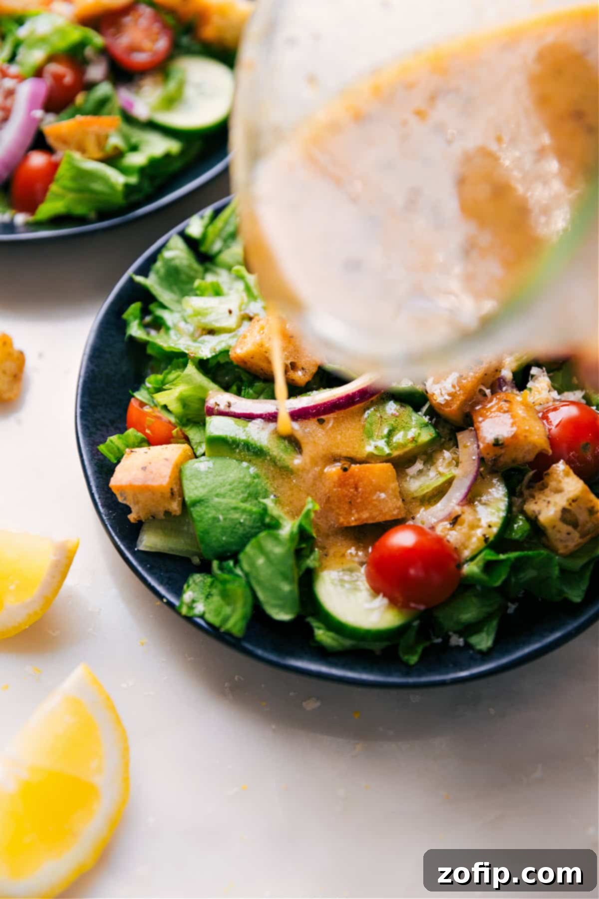 Vibrant Lemon Vinaigrette drizzled generously over a fresh green salad.