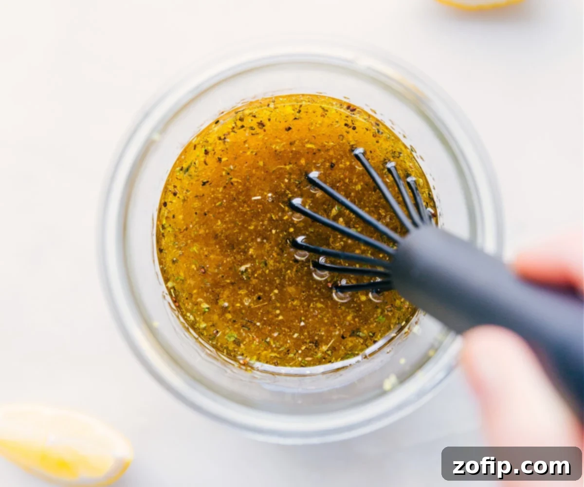 Close-up of Lemon Vinaigrette being whisked until perfectly emulsified and smooth.