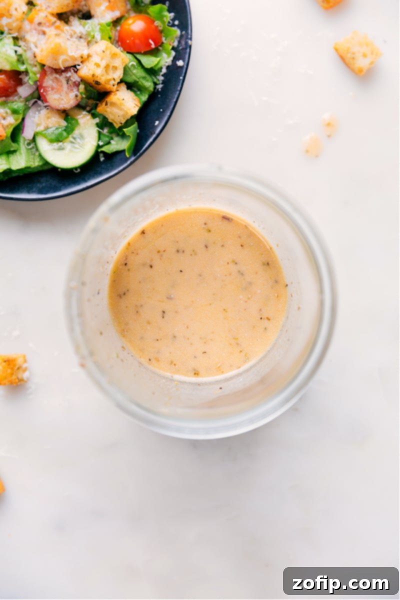 Overhead image of freshly made Italian Dressing in a glass jar, ready to be served or stored.