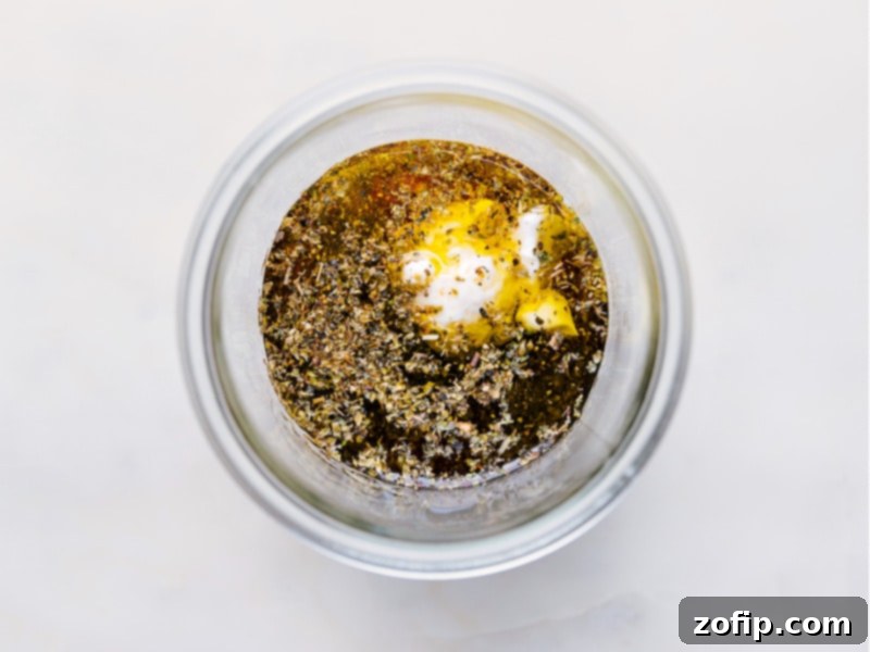 Process shots showing various ingredients being added sequentially to a glass jar to make homemade Italian salad dressing.