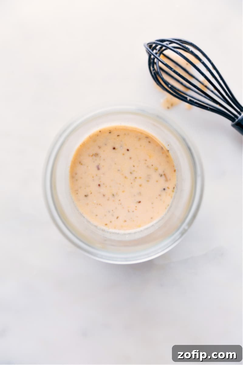 Overhead image of a prepared salad with Italian Dressing generously poured over it, ready to be enjoyed.