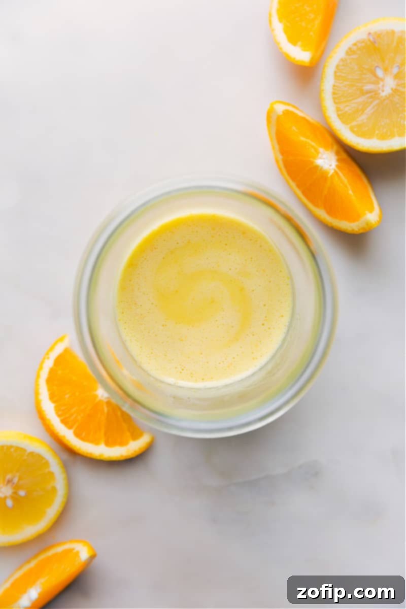 Bright and Zesty Homemade Citrus Vinaigrette with Fresh Lemon and Orange Overhead image of the Citrus Vinaigrette in a jar