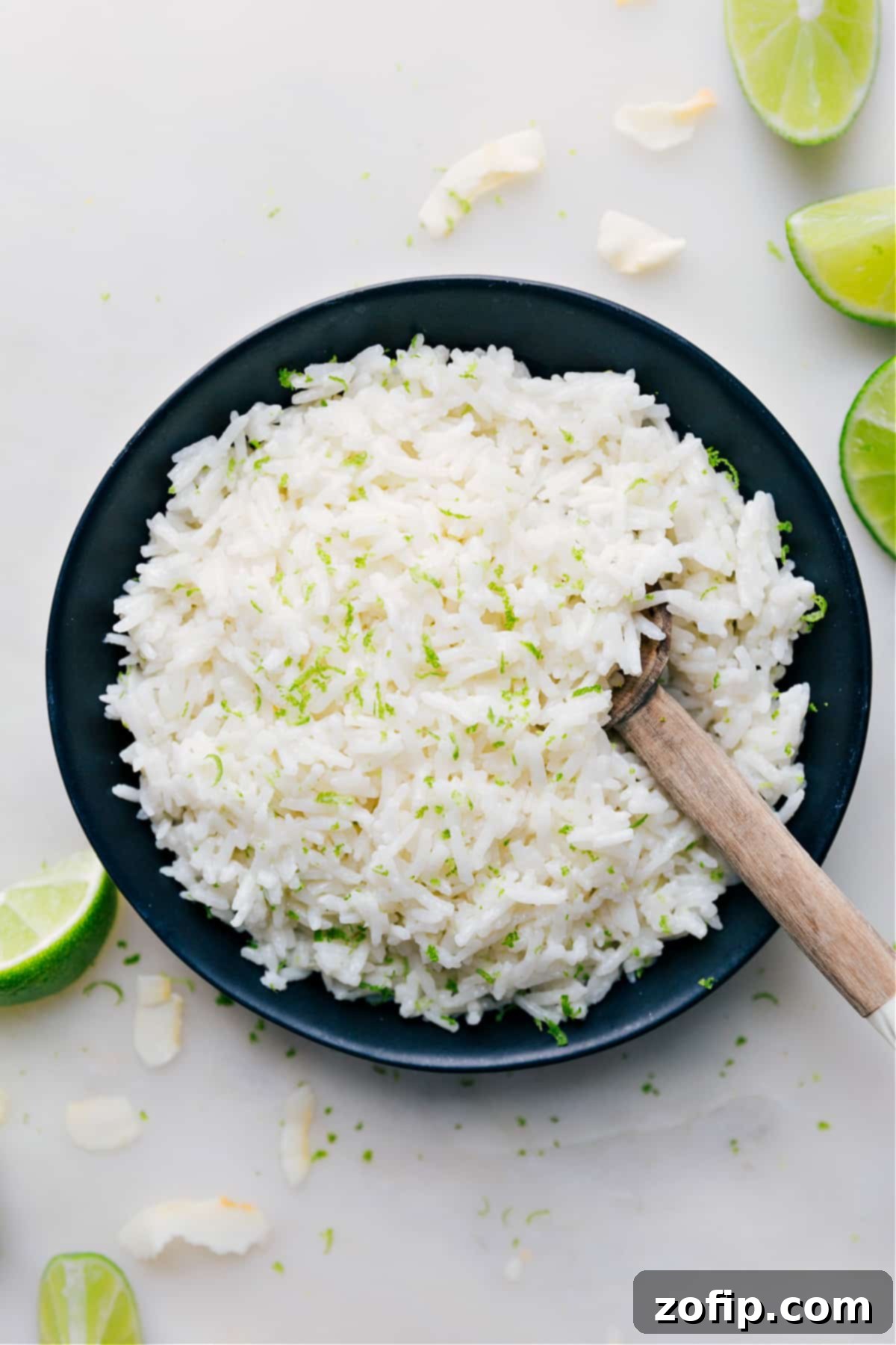 The Best Coconut Rice Recipe A bowl of fluffy Coconut Rice topped with vibrant fresh lime zest, ready to be served.