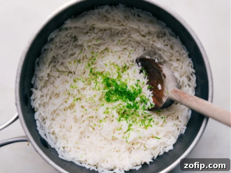 Lime And Coconut Rice Recipe Finished Coconut Rice being enhanced with fresh lime zest and a squeeze of lime juice for brightness.