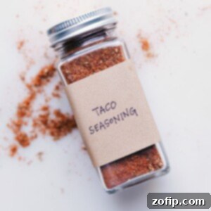 Homemade Taco Seasoning in a small bowl with spices around it.