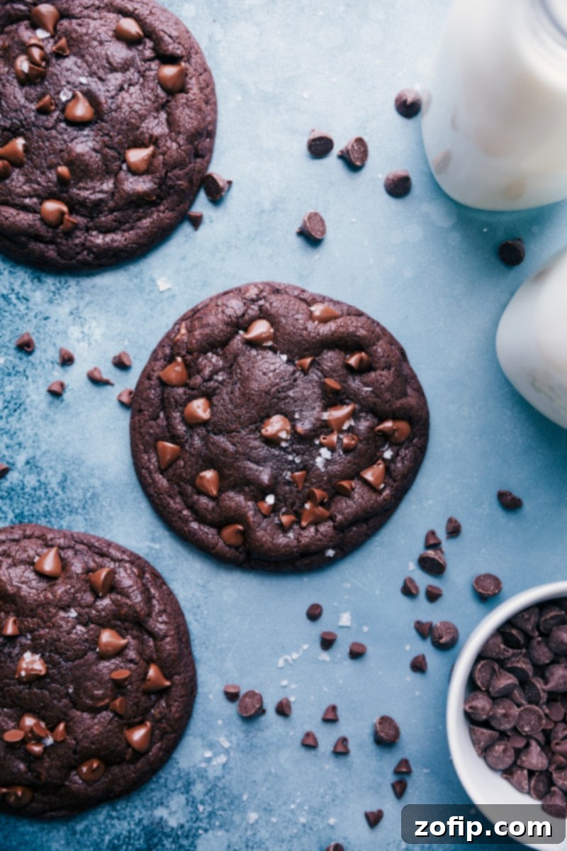 An inviting overhead shot of warm, freshly baked Bakery Style Chocolate Cookies, garnished with a sprinkle of sea salt.