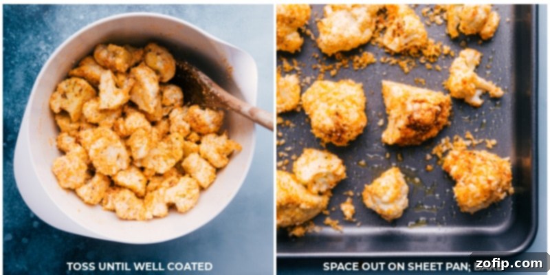 Seasoned cauliflower florets spaced out on a baking pan, ready for roasting