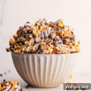 Tuxedo Popcorn 2 Close-up of Zebra Popcorn with a clear view of the chocolate drizzles and caramel coating.