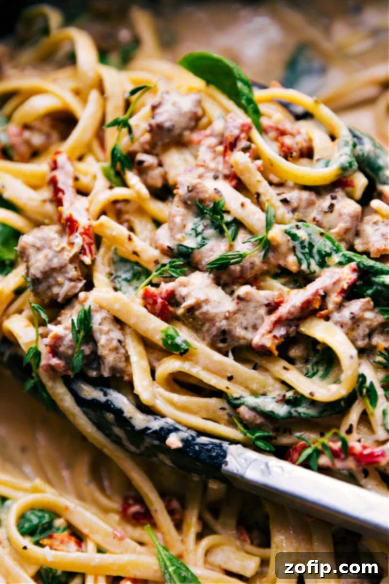 Up-close overhead image of Creamy Sausage Pasta in a large pot, ready to be served.