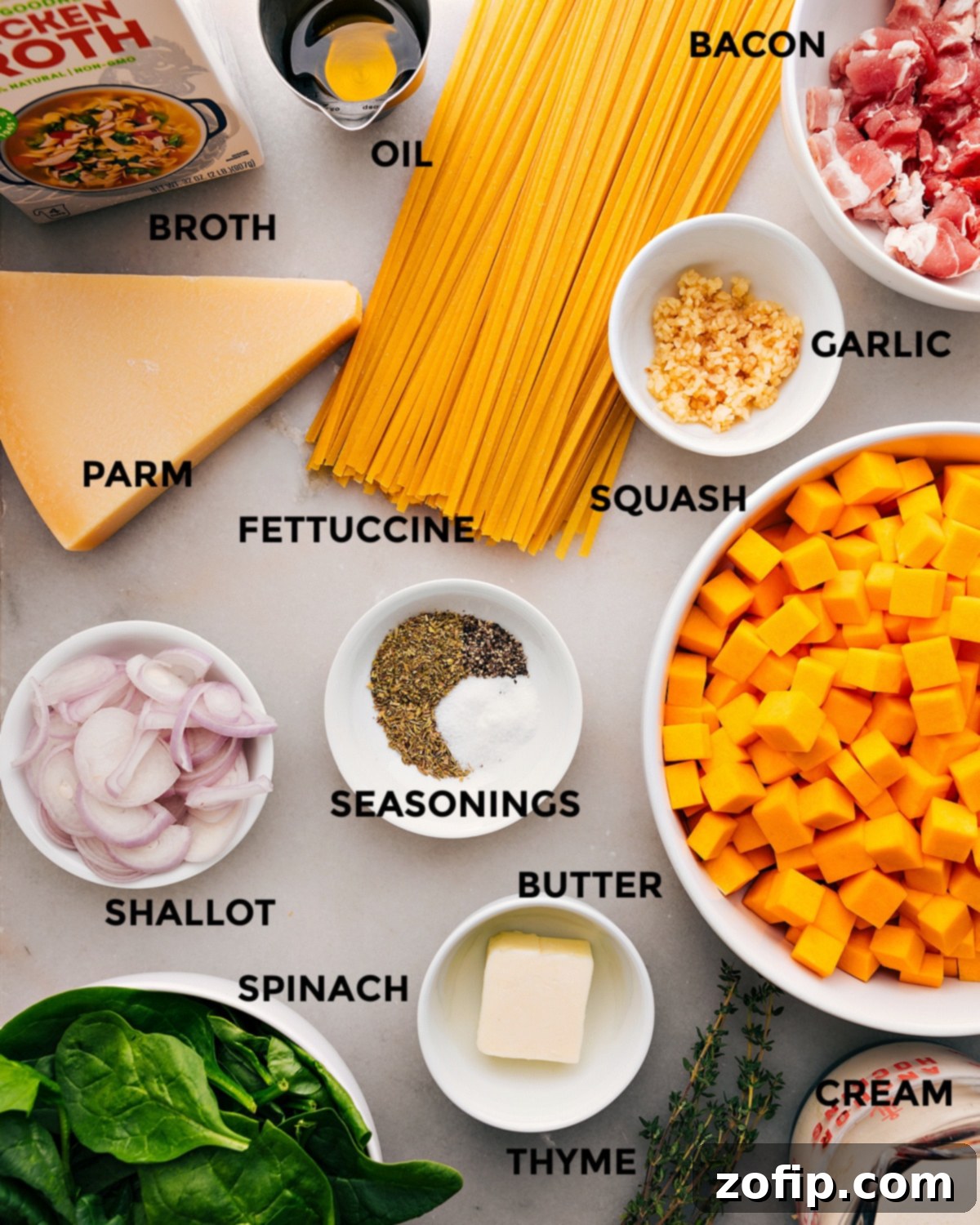 Key Ingredients For Butternut Squash Pasta Recipe All the ingredients for this Butternut Squash Pasta recipe are prepped and ready for easy assembly, including fettuccine, garlic, bacon, olive oil, chicken broth, Parmesan cheese, shallots, butter, and fresh vegetables like butternut squash and spinach.