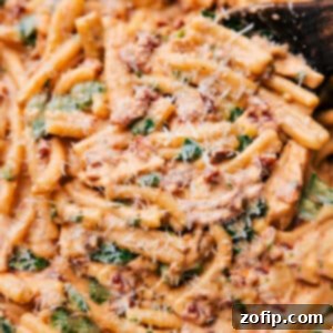 A delicious plate of Marry Me Pasta, featuring creamy sauce, tender chicken, and vibrant sun-dried tomatoes, garnished with fresh herbs.