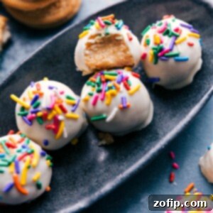 Finished Golden Oreo Truffles on a platter, showcasing their beautiful white chocolate coating and optional decorations.