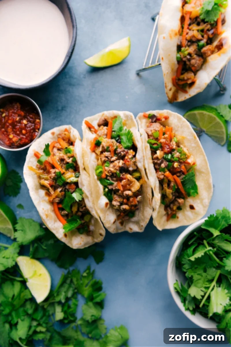 Delicious Asian Pork Tacos with spicy mayo drizzle and fresh cilantro