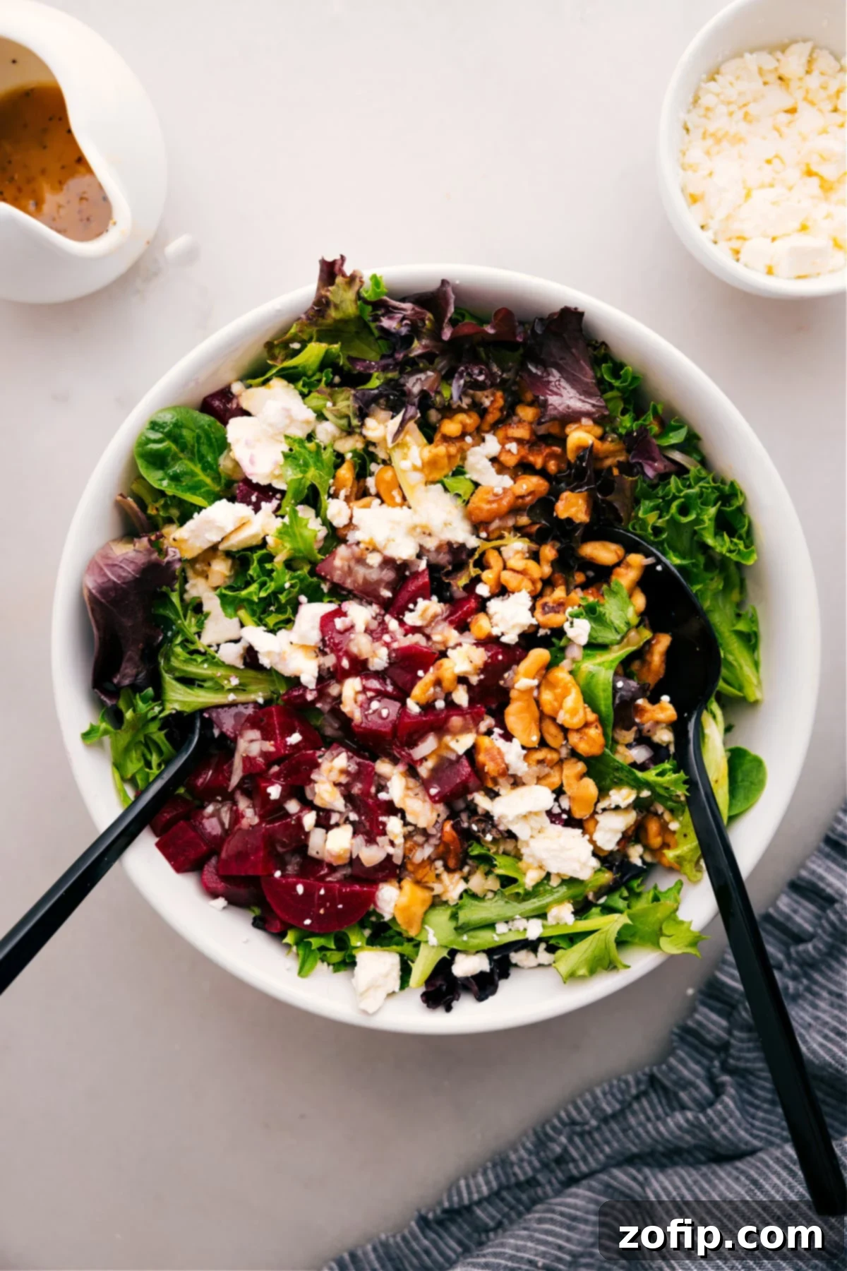 A beautifully arranged bowl of Beet, Goat Cheese, and Walnut Salad, drizzled with a delicious honey-Dijon dressing and ready to be enjoyed.