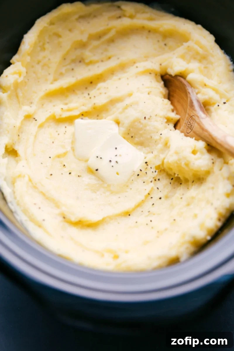 Ready-to-Enjoy Crockpot Mashed Potatoes with Butter Topping The finished crockpot mashed potato recipe topped with a dollop of butter, ready to be enjoyed.