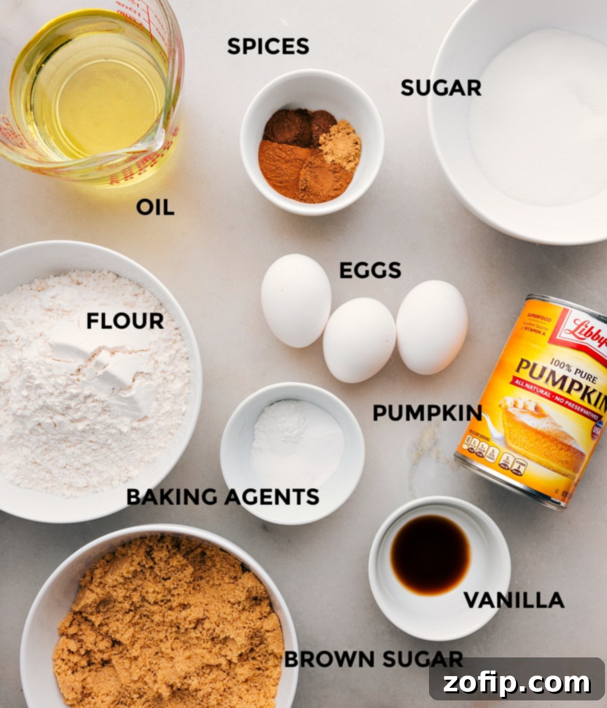 Key Ingredients for the Best Pumpkin Bars Recipe All the essential ingredients for baking perfect pumpkin bars, including fresh pumpkin puree, sugars, spices, eggs, flour, and baking agents, neatly arranged on a counter.