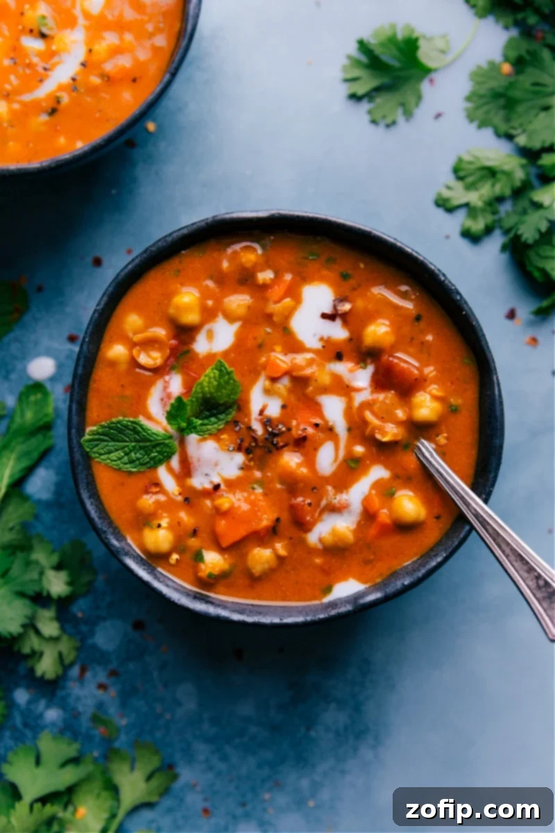 Delicious Vegan Chickpea Soup with Lentils and Coconut Curry Overhead image of a vibrant bowl of chickpea soup, rich with lentils, chickpeas, and a creamy coconut curry broth