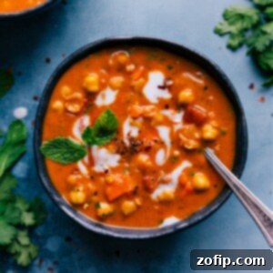 Hearty Chickpea Stew 2 A bowl of delicious Chickpea Soup garnished with fresh herbs and a drizzle of coconut milk