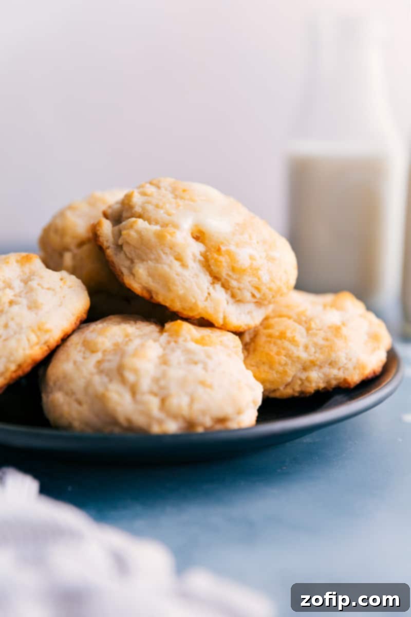 The easiest homemade Drop Biscuits – hot, buttery, and flaky perfection! A plate brimming with golden, freshly baked drop biscuits, ready to be enjoyed.