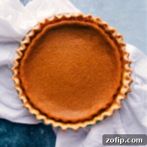 The ultimate Pumpkin Pie, a classic fall dessert with a rich, creamy filling and buttery crust, perfect for holidays.