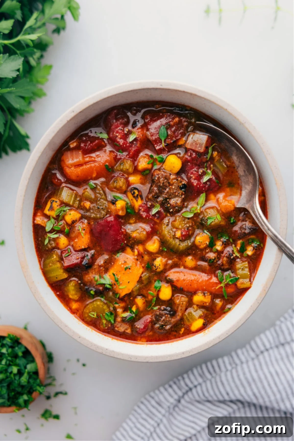 A steaming bowl of hearty Sweet Potato Stew, garnished with fresh parsley, ready to be enjoyed.